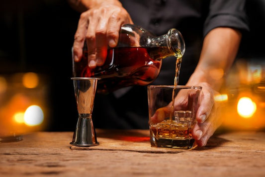 bartender pouring high-end bourbon whiskey into glass