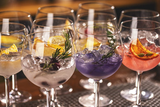 multiple gin cocktails with different gin mixers on bar