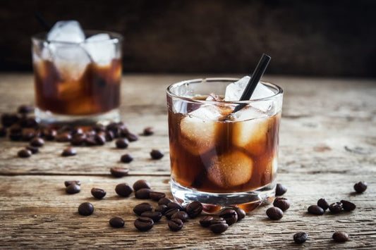 two black russians on wooden bar with espresso beans