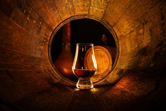 bourbon glass in an oak barrel