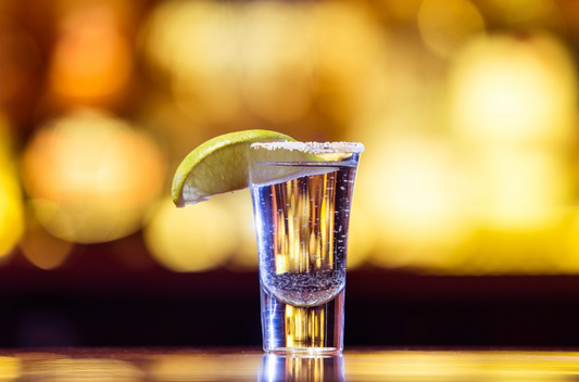 dos hombres mezcal in shot glass with salt and lime on bar