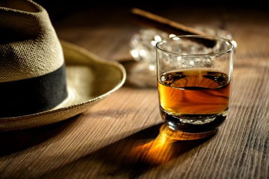 glass of sipping rum with panama hat