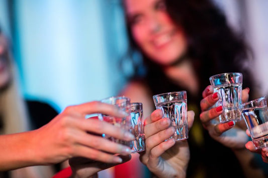 group of people toasting goza tequila shots