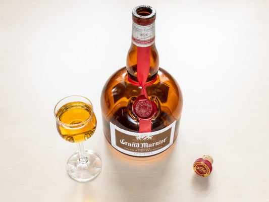 grand marnier bottle with glass on white background