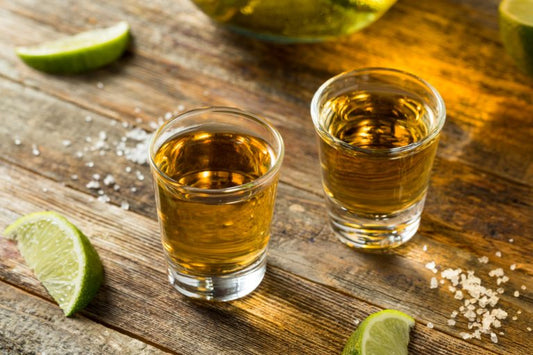 reposado tequila glasses on table with lime