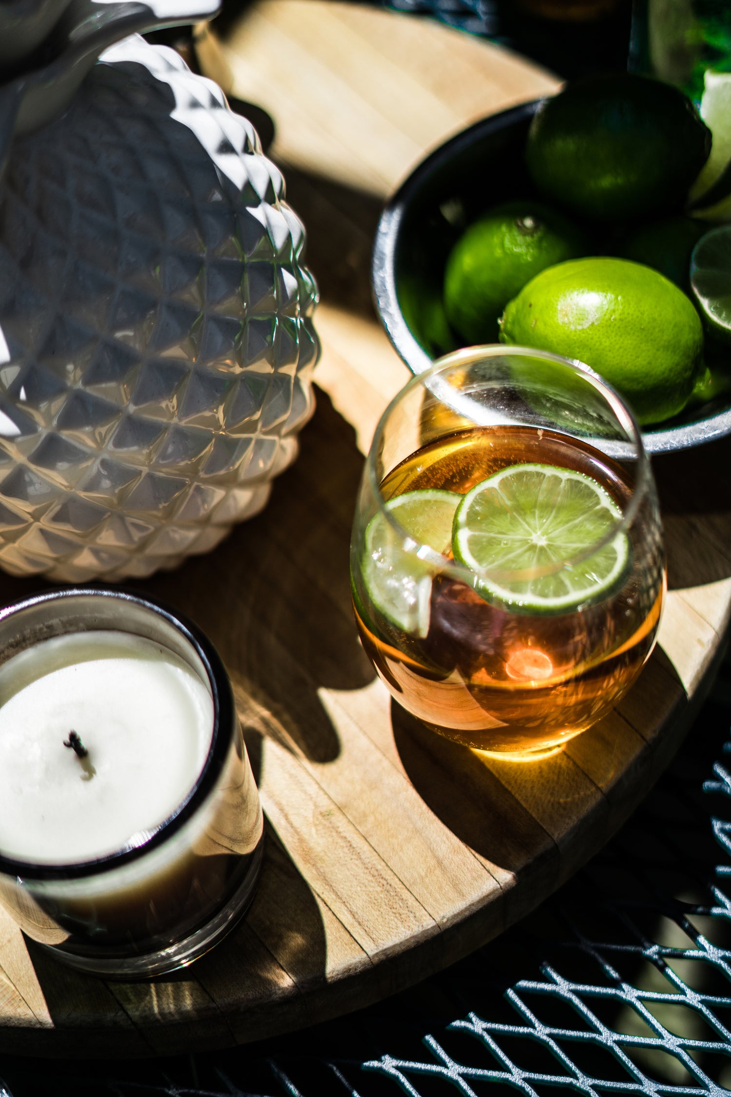 tequila cocktail garnish with limes on a table next to a bowl of limes