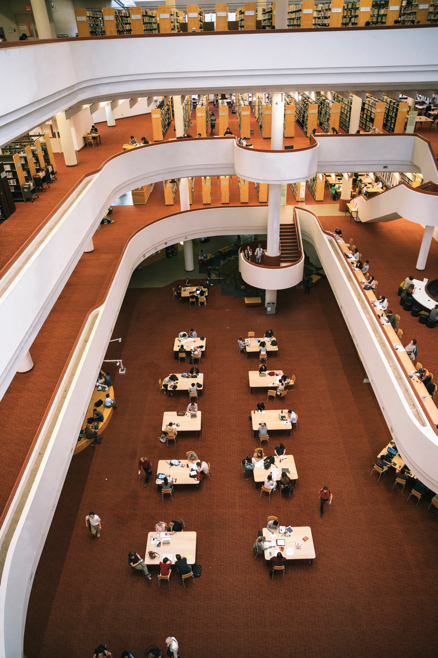 modern library overlooking tables of people studying