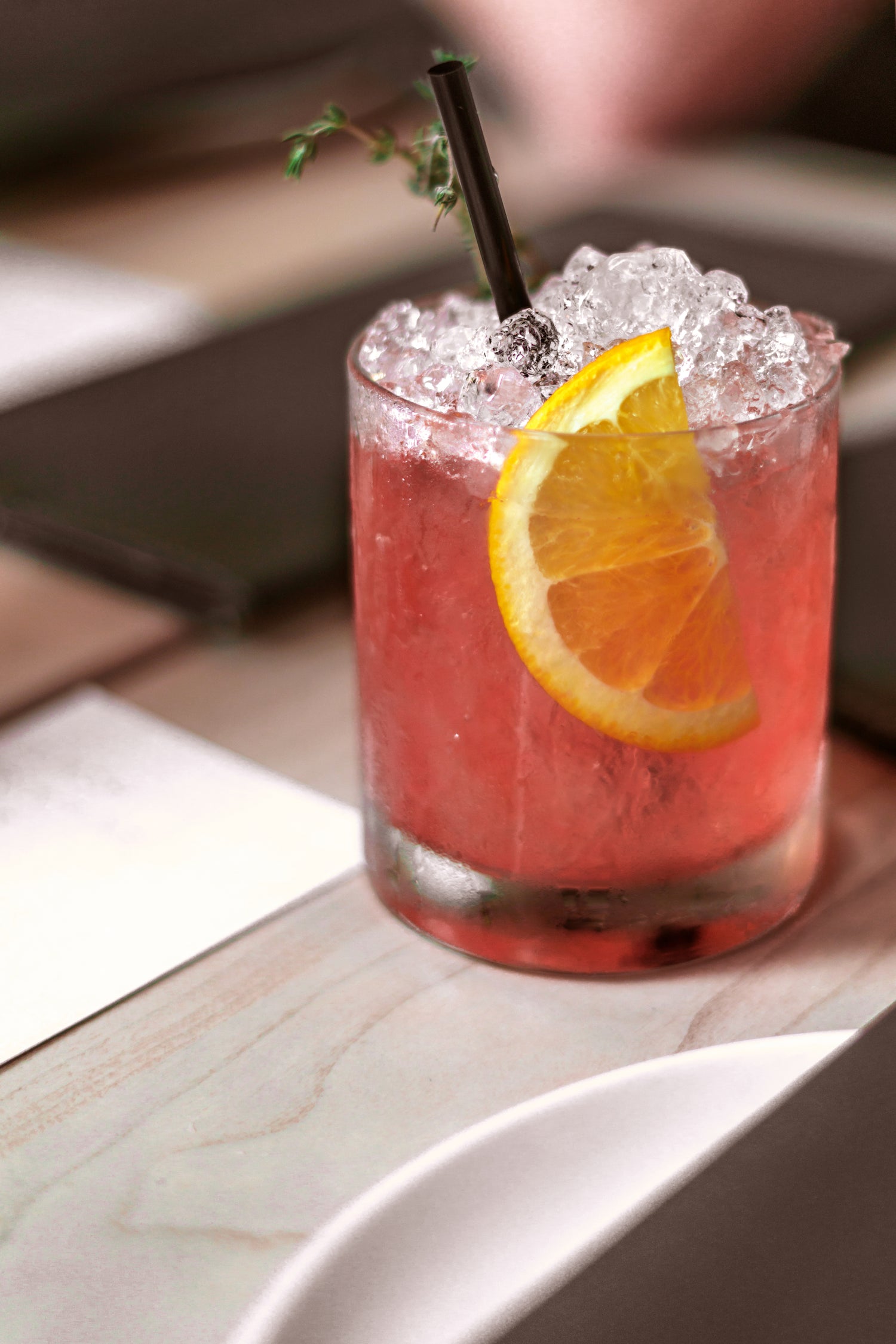 refreshing summer cocktail with straw on a wooden table