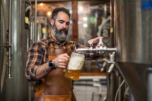 bearded man pouring rogue brewery beer in glass