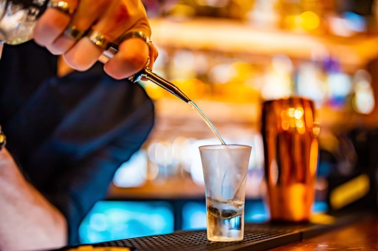 bartender pouring green tea shot into shot glass