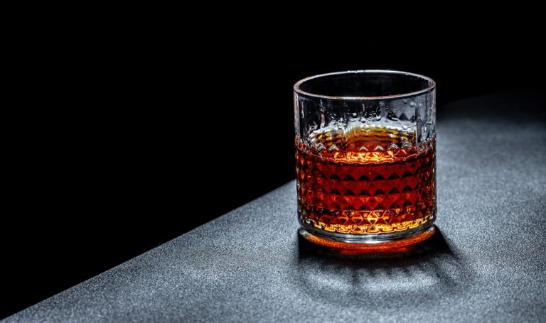 pinkhook bourbon in glass on slate table