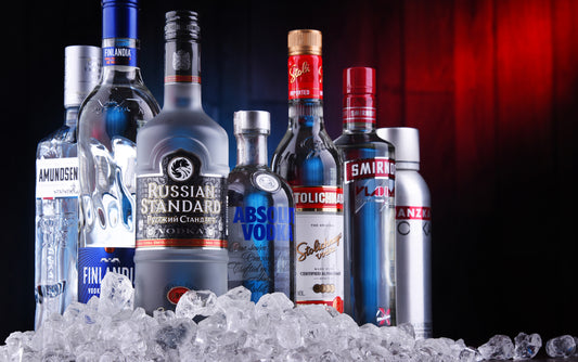 several brands of vodka bottles standing on ice