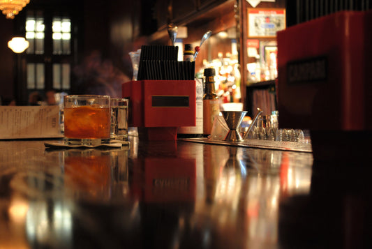 dallas speakeasy bar counter with bar tending tools and liquor in the background