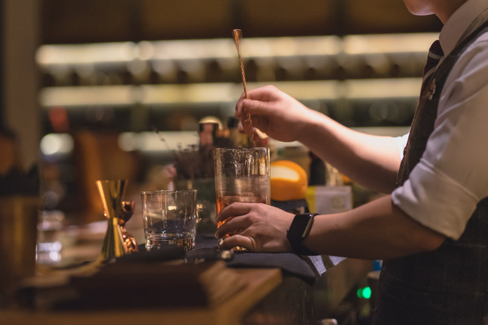 bartender making a cocktail at a speakeasy bar in philadelphia