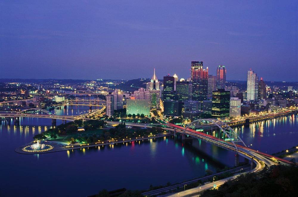 pittsburgh city view at night with bridges and water in view