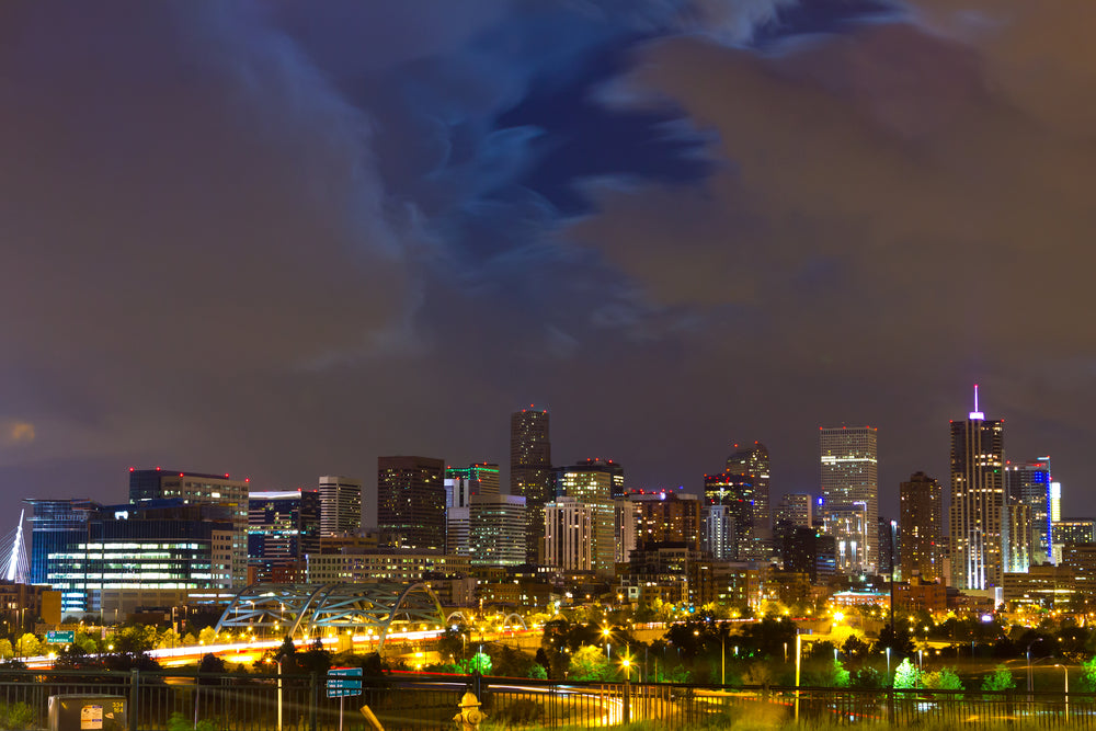 denver skysline at night with a cloudy dark sky