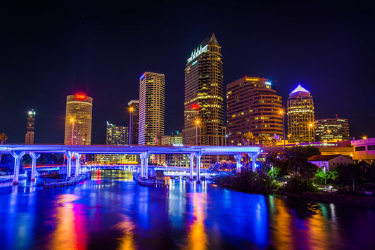  tampa skyline at night with neon lights and the ocean bay in the view