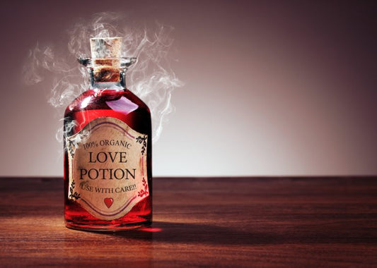 smoking bottle labeled love potion with an aphrodisiac drink inside