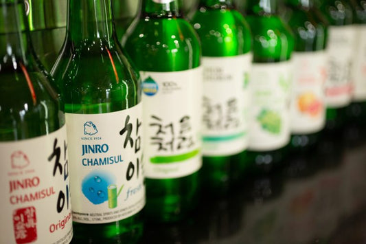 soju bottles lined up on liquor shelf