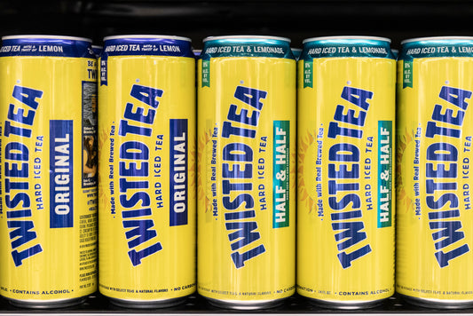 twisted tea cans against black background